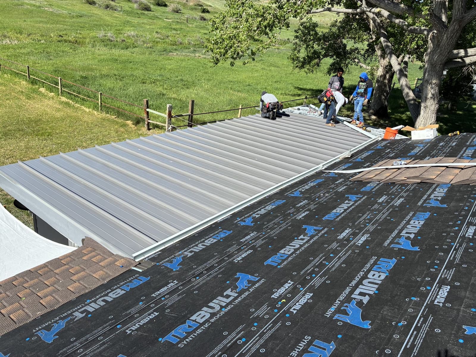 Professional inspection of a metal roof for wind damage and uplift