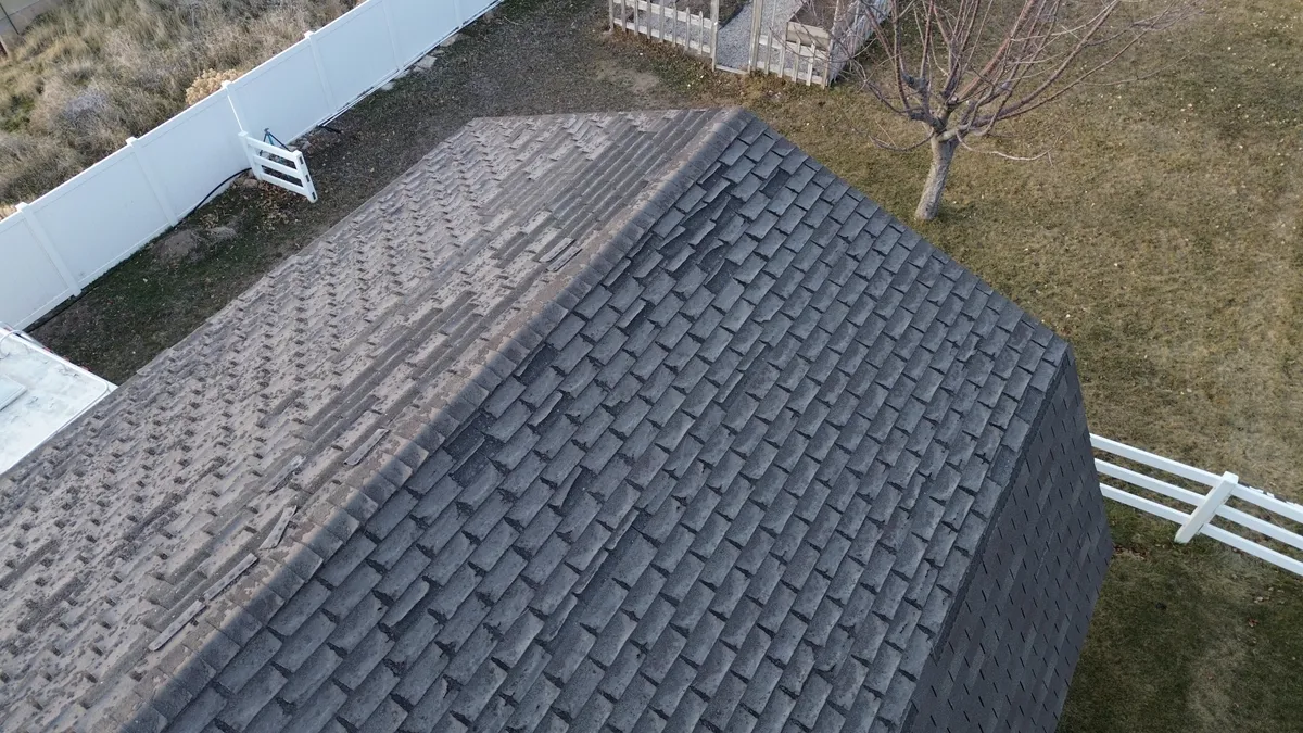 Ponding water on a low-slope roof showing what happens when drainage design fails
