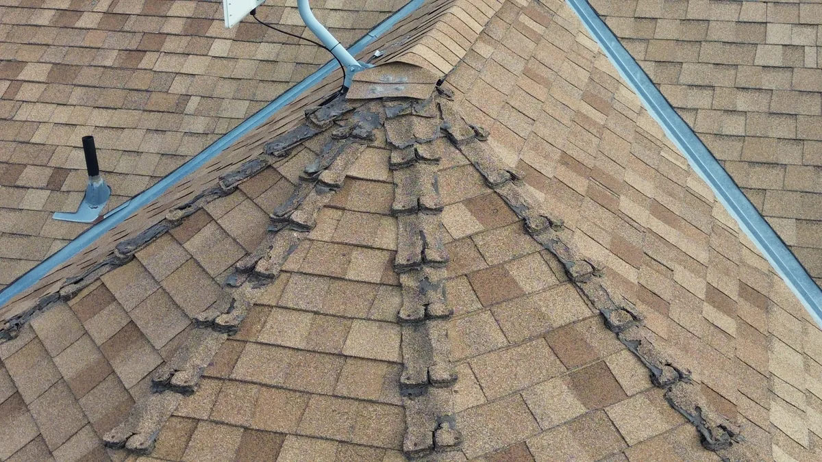 Storm-damaged roof showing when replacement may be smarter than repeated repairs