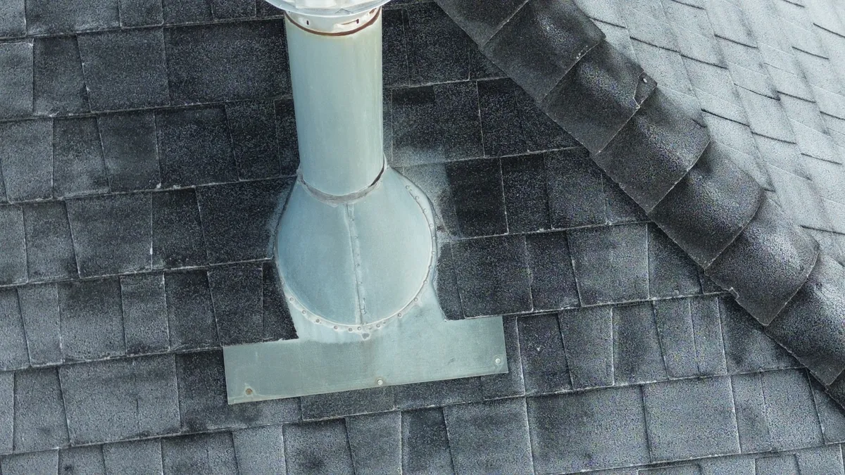 Standard turtle vent installed on a shingle roof plane