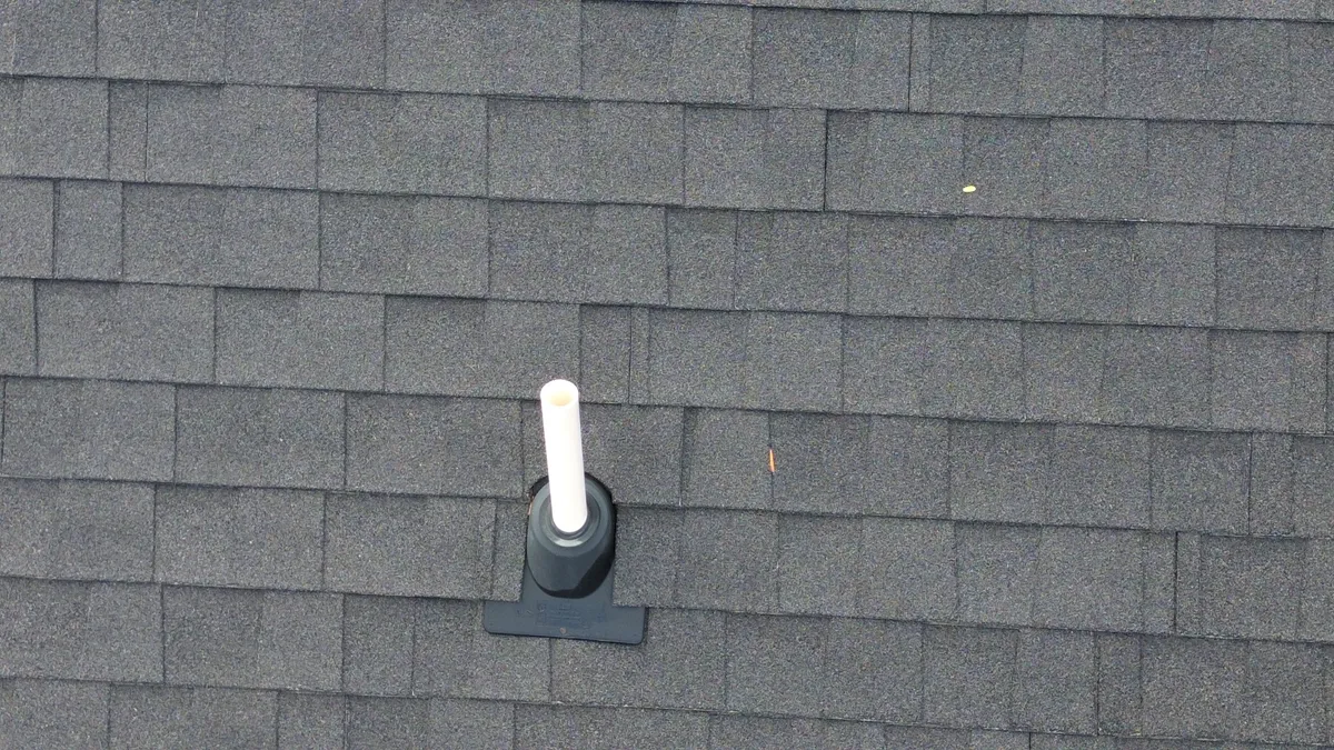 Low-slope roof section with drifted snow accumulation and potential for ice dams