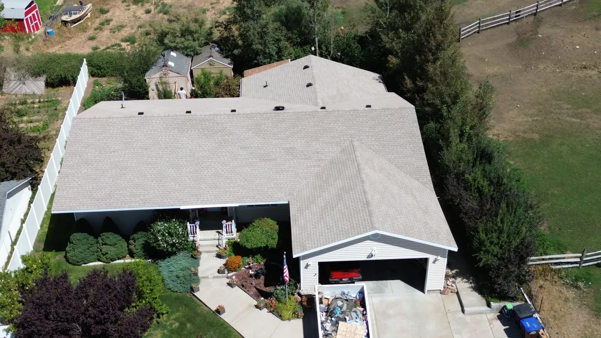 Roofing crew starting a tear-off at sunrise for a fast 1-day replacement