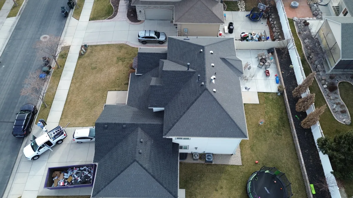 Detailed metal roof flashing work around a chimney in a heavy snow area