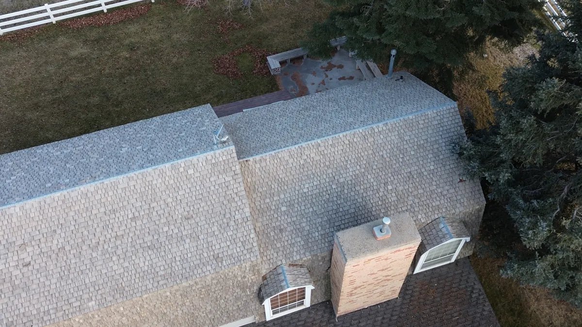 Old gutters being removed during a full roof tear-off