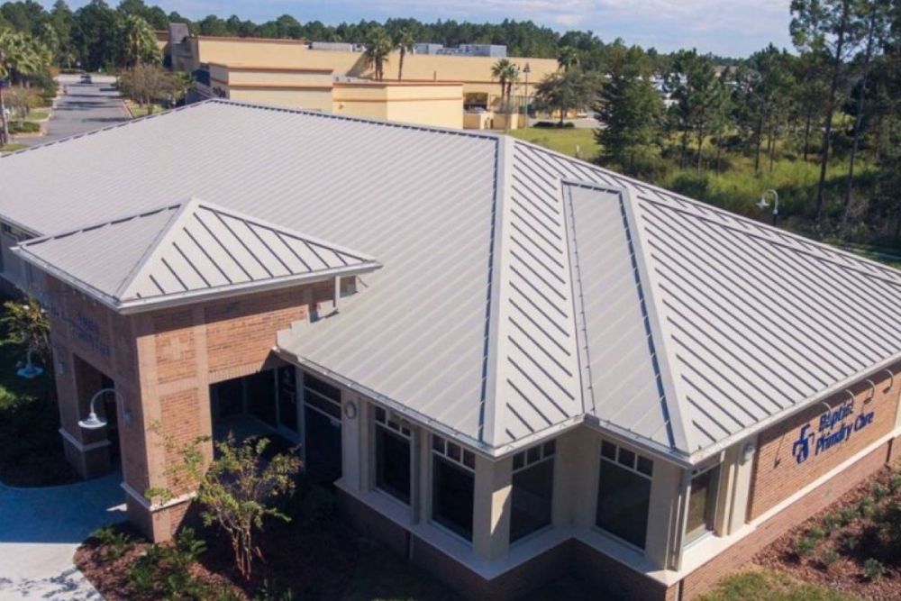 Commercial flat roof drains and crickets used to support low-slope drainage design