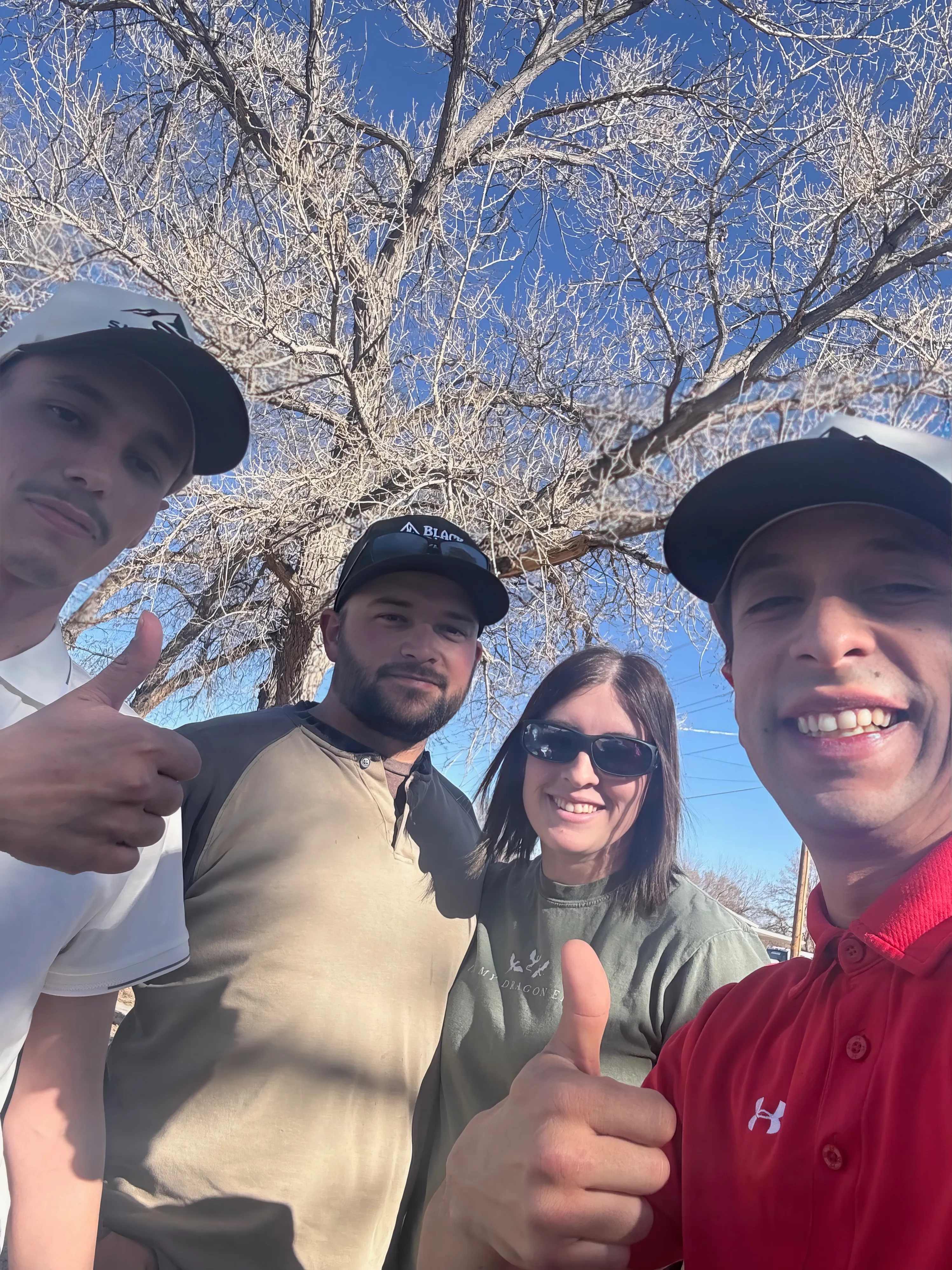 Sky Ridge Roofing team with happy homeowner and dog
